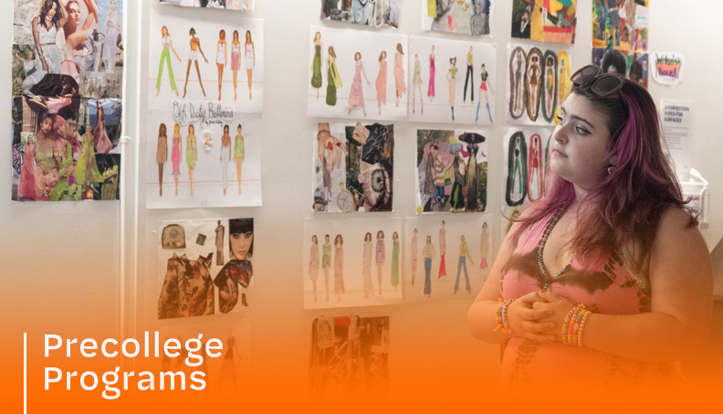 student looking at fashion drawings